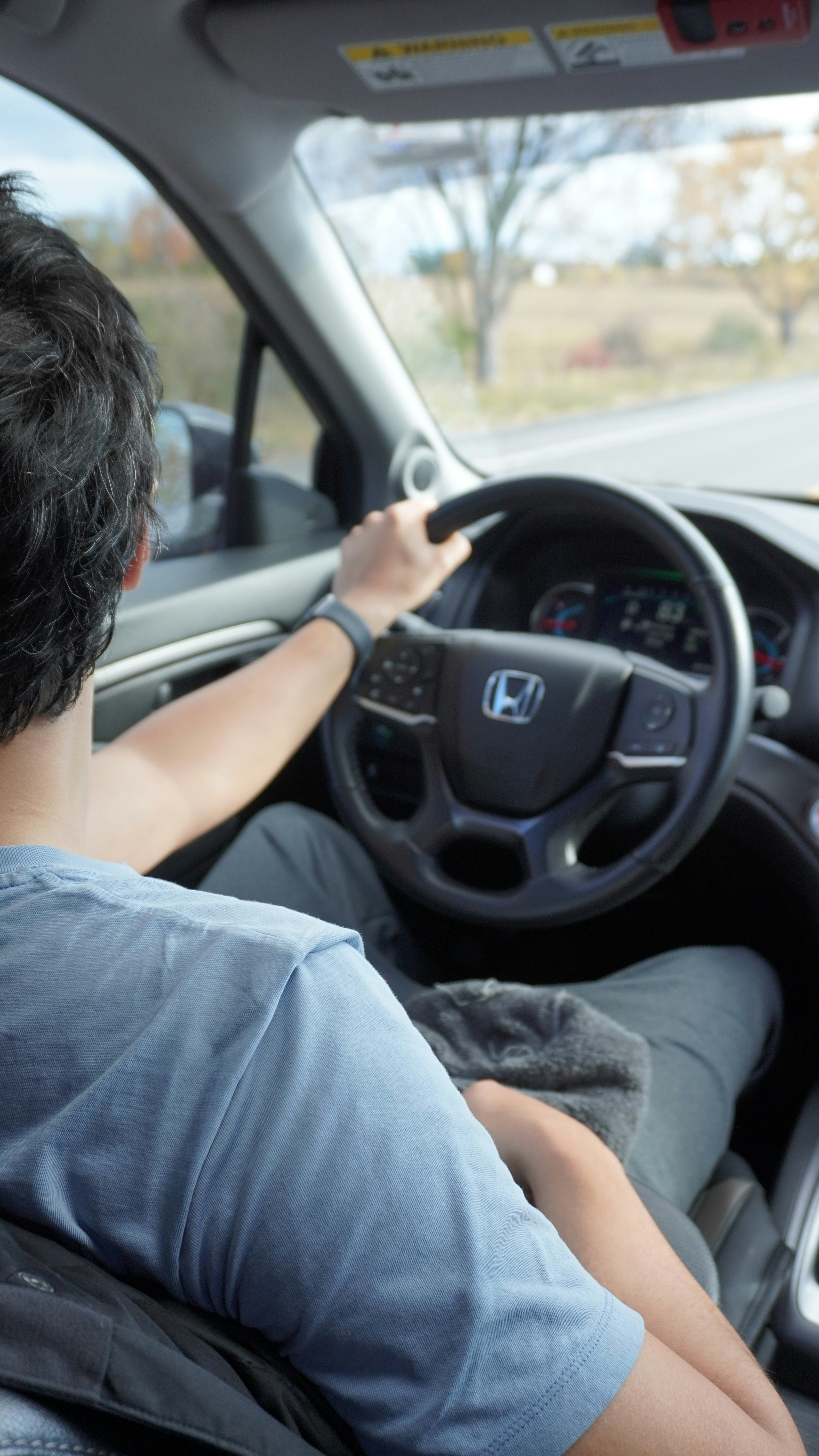 A man driving a car down a street