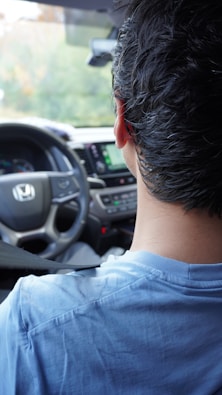 A man driving a car on a city street