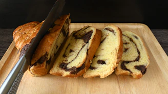 A wooden cutting board topped with chocolate chip cookies