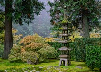A garden with a stone bench in the middle of it