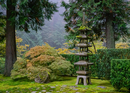 A garden with a stone bench in the middle of it
