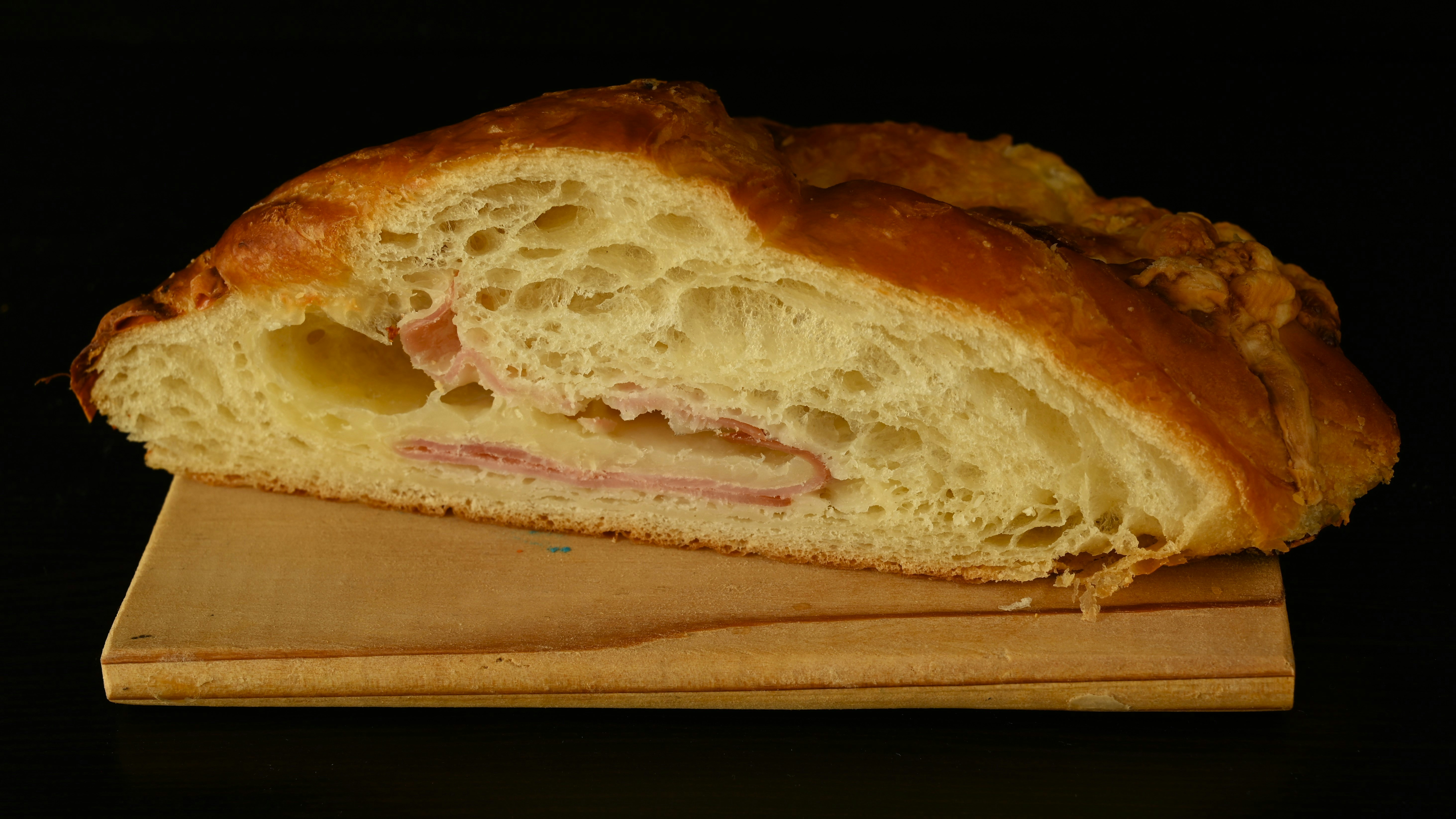 A piece of bread that is sitting on a cutting board