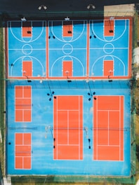 An overhead view of a blue and orange basketball court