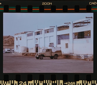 A truck is parked in front of a building