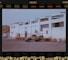 A truck is parked in front of a building