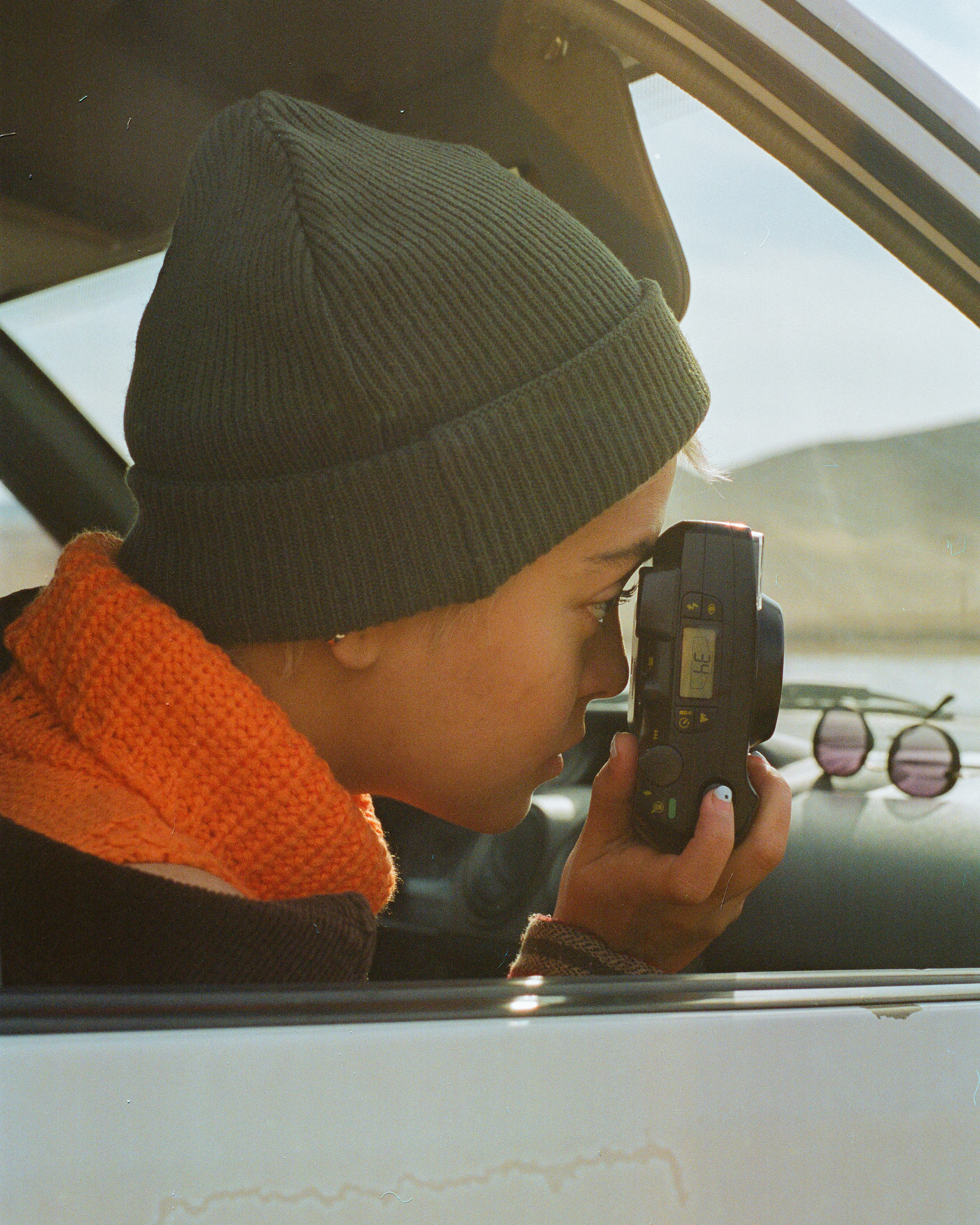A person in a car taking a picture with a cell phone