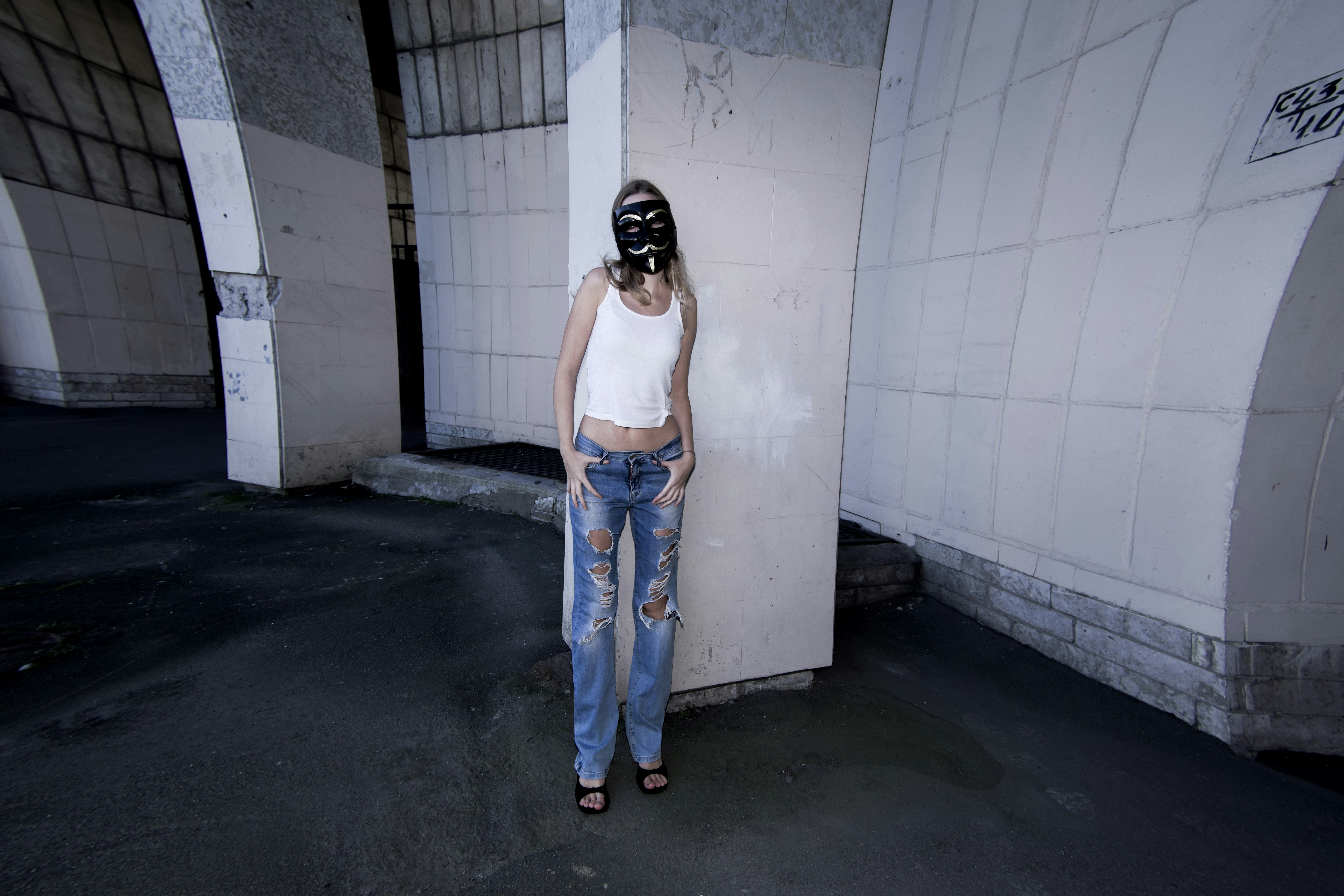 A woman wearing a gas mask standing in a tunnel