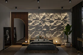 A bedroom with a stone wall and a large bed