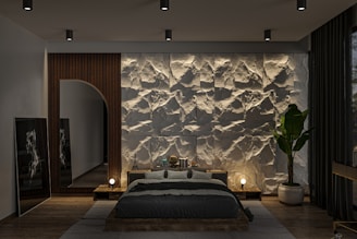 A bedroom with a stone wall and a large bed