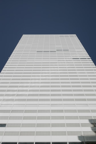 A tall white building with a sky background