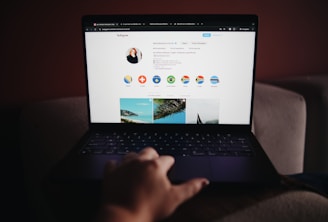 A person sitting on a couch using a laptop