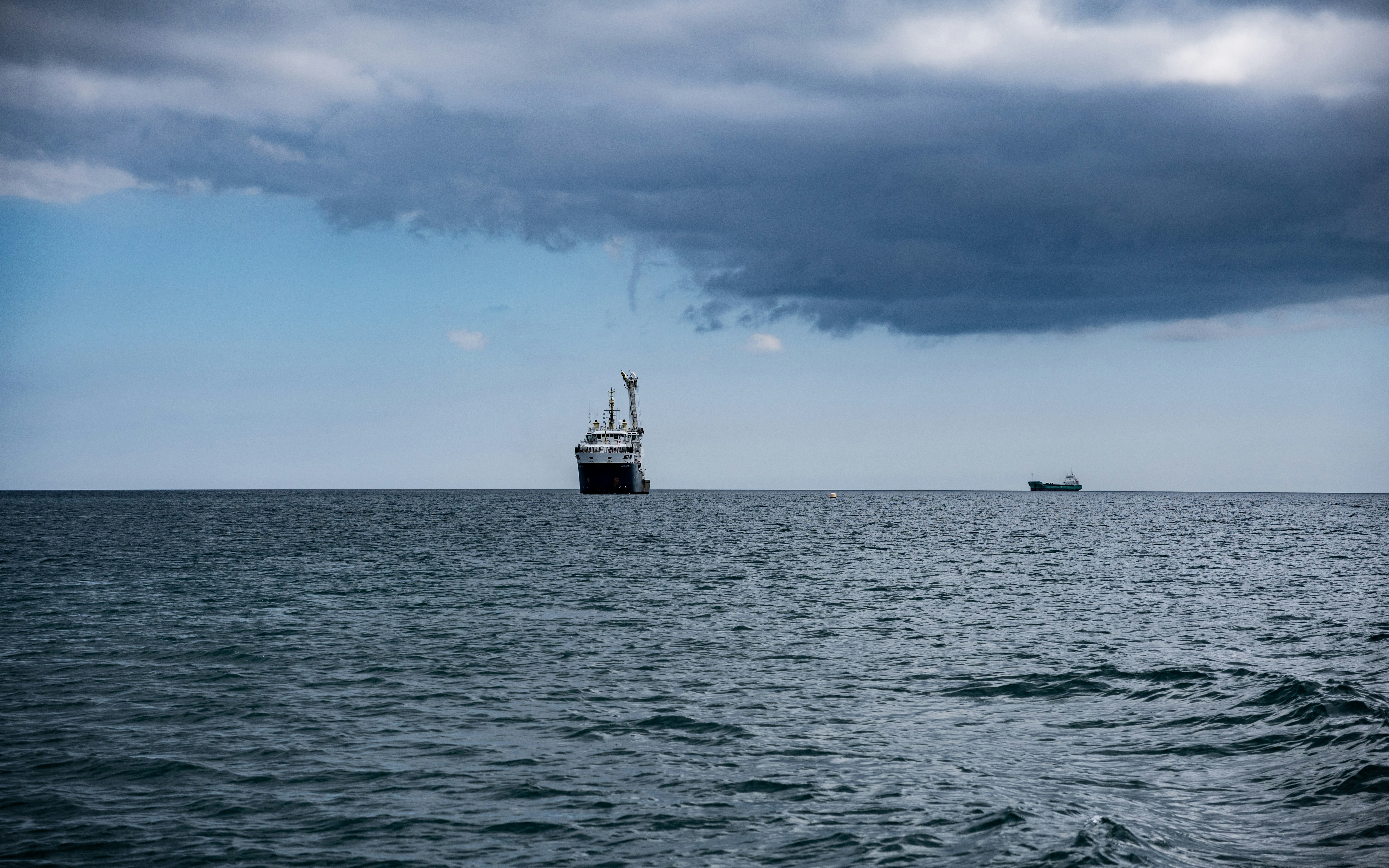 A large boat floating on top of a large body of water