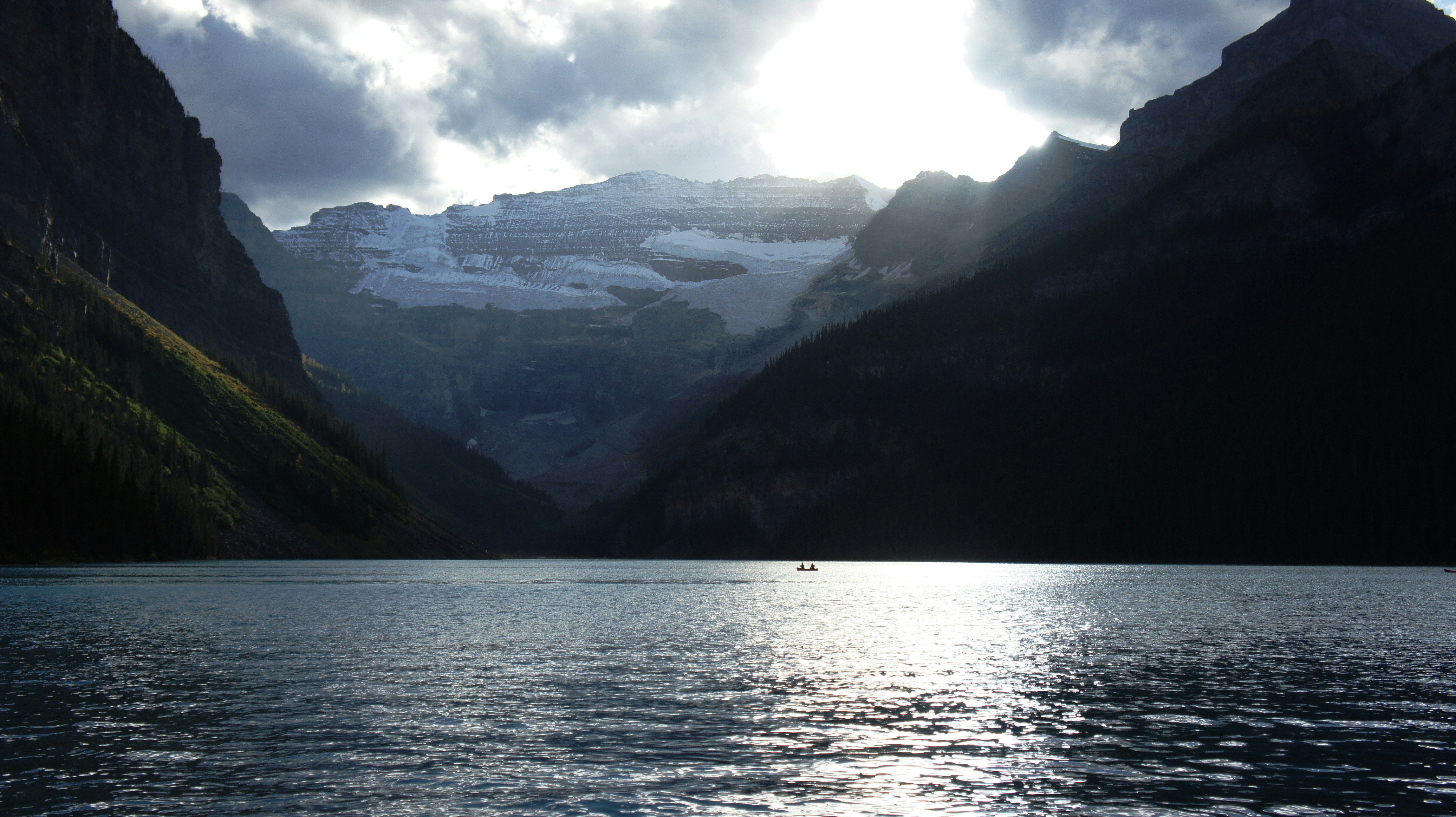 A body of water with mountains in the background