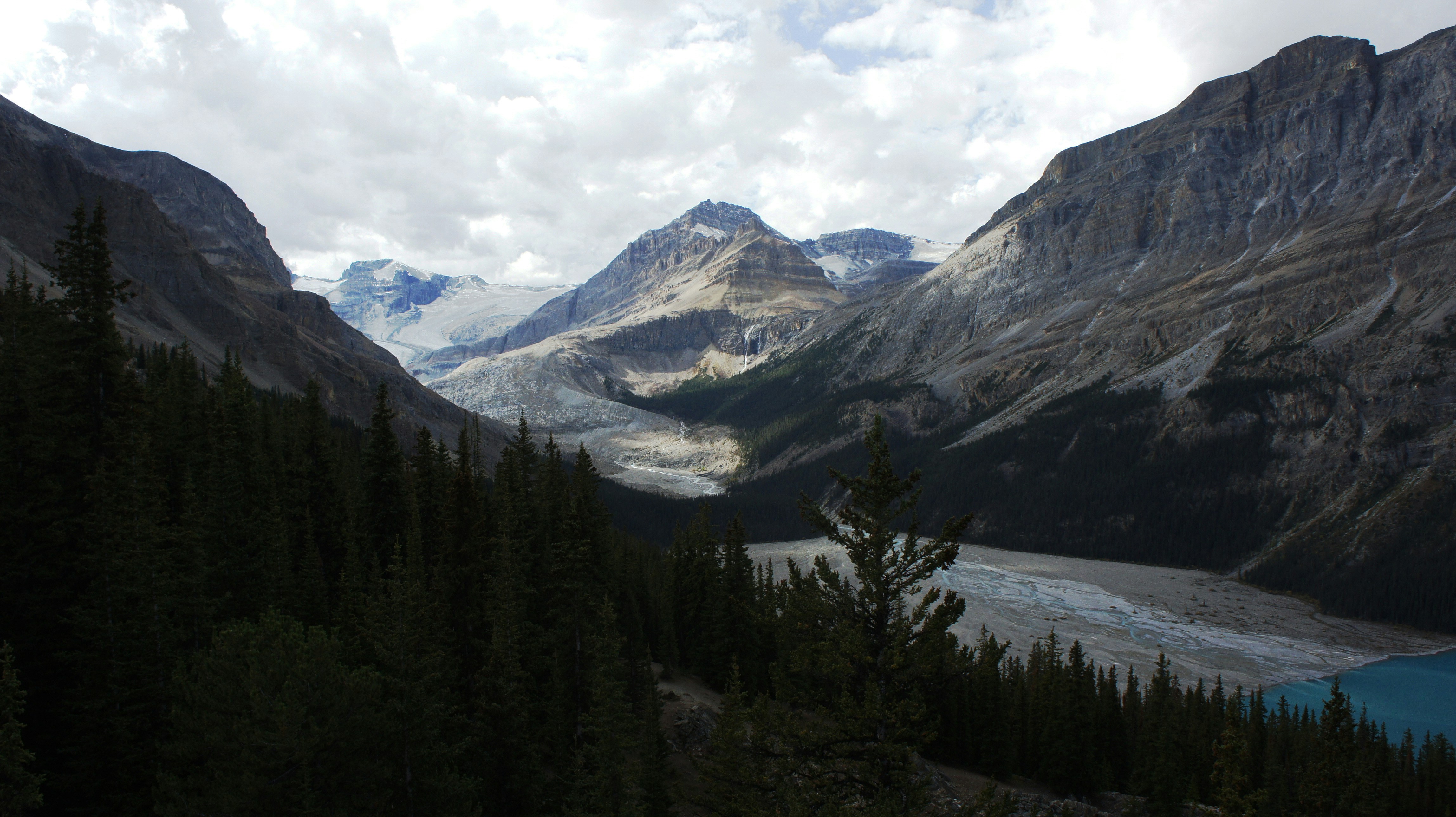 A scenic view of a mountain lake surrounded by trees