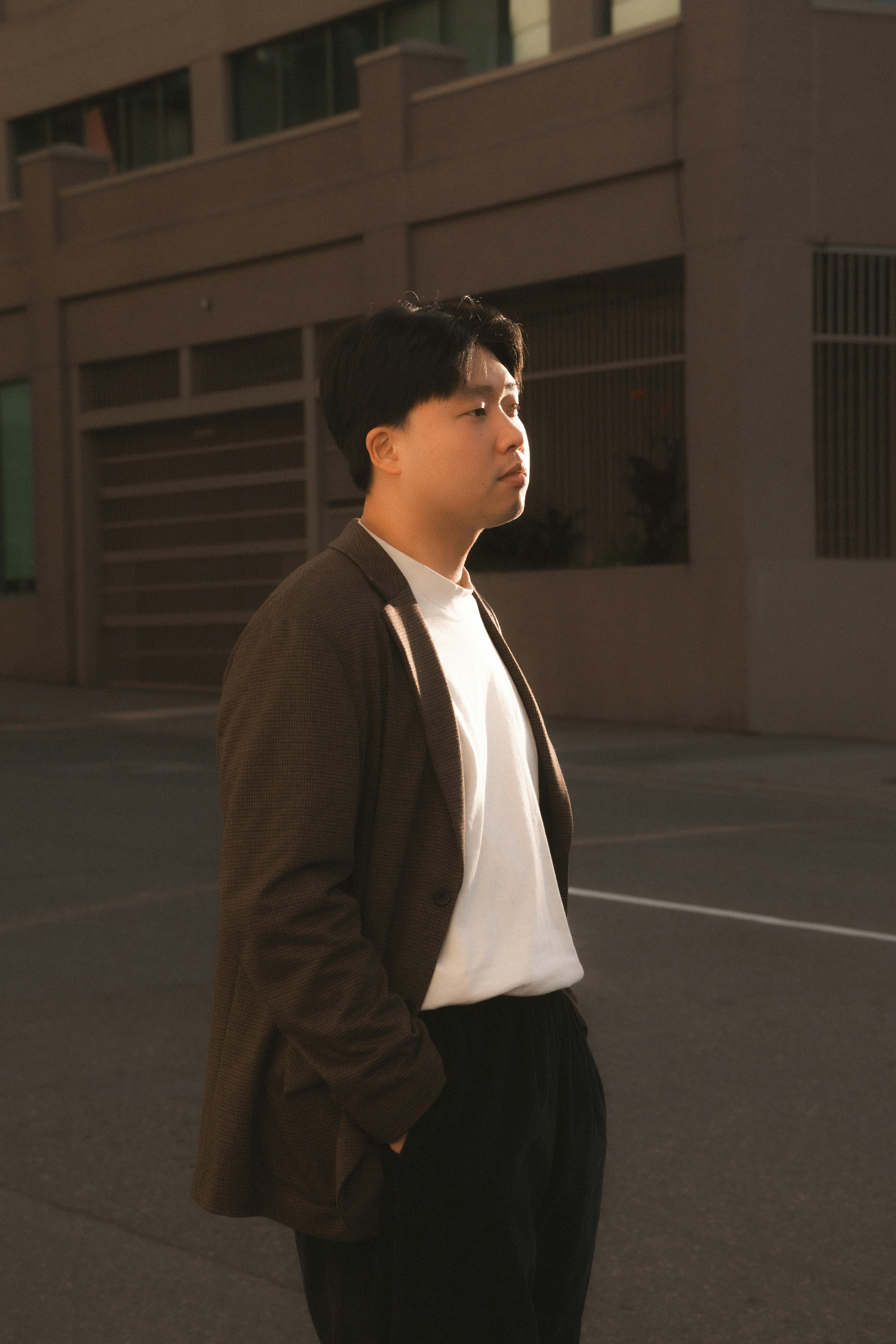 A man standing in the middle of a parking lot