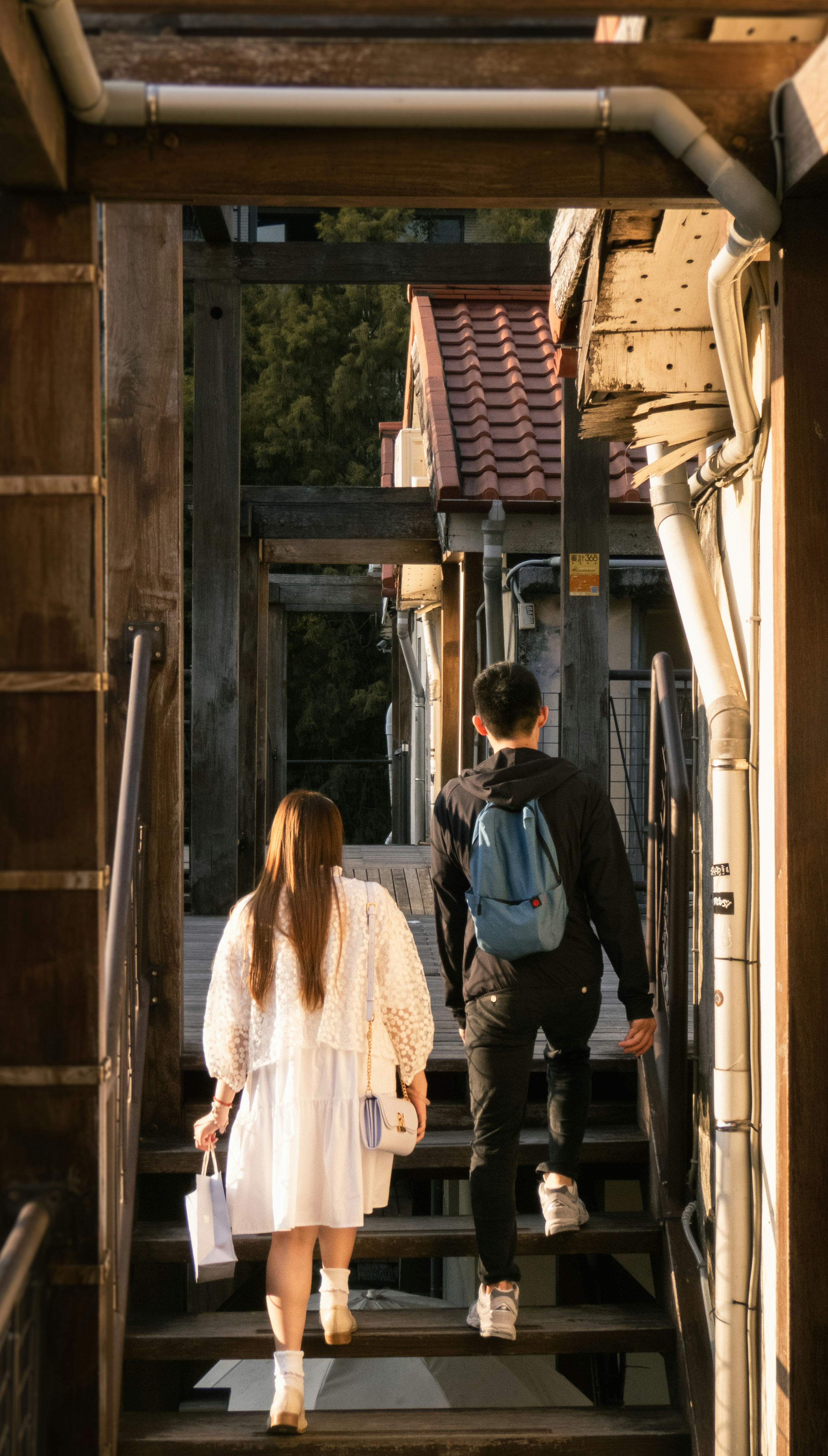A man and a woman walking up a flight of stairs