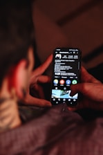 A person holding a cell phone in their hand