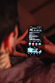 A person holding a cell phone in their hand