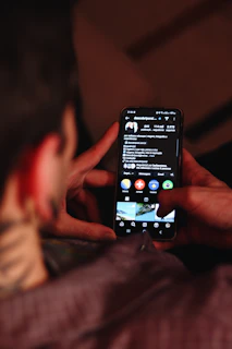 A person holding a cell phone in their hand