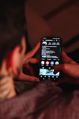 A person holding a cell phone in their hand