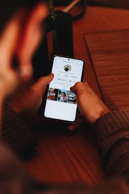 A person holding a cell phone in their hand