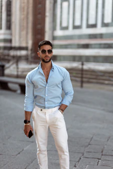 A man in a blue shirt and white pants