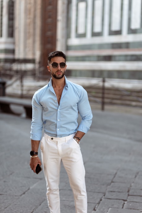 A man in a blue shirt and white pants