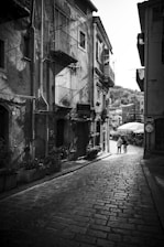 A black and white photo of a cobblestone street