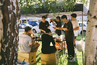 A group of young men sitting around a picnic table
