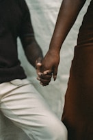 A man and a woman holding hands while standing next to each other