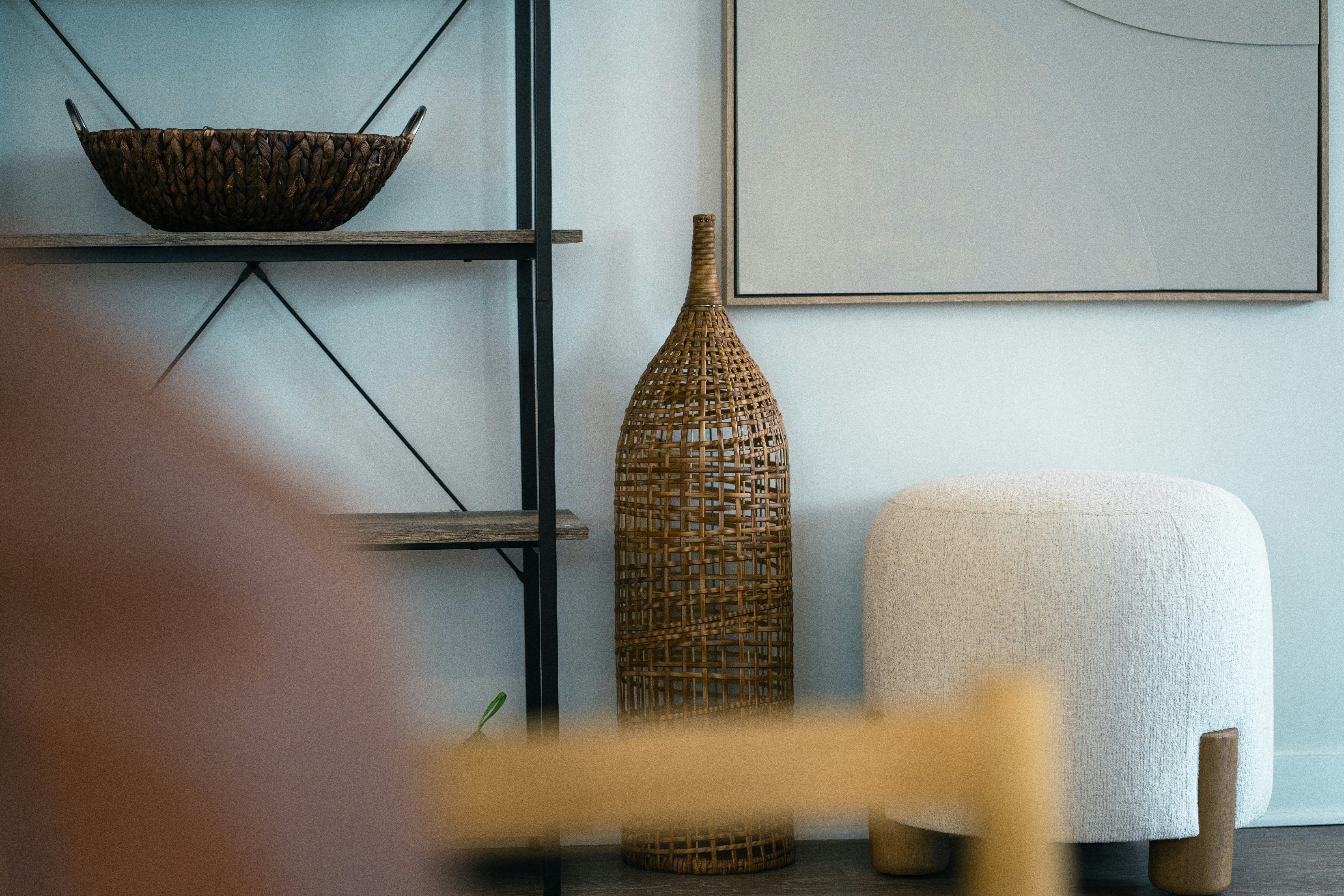 A living room with a chair and a vase