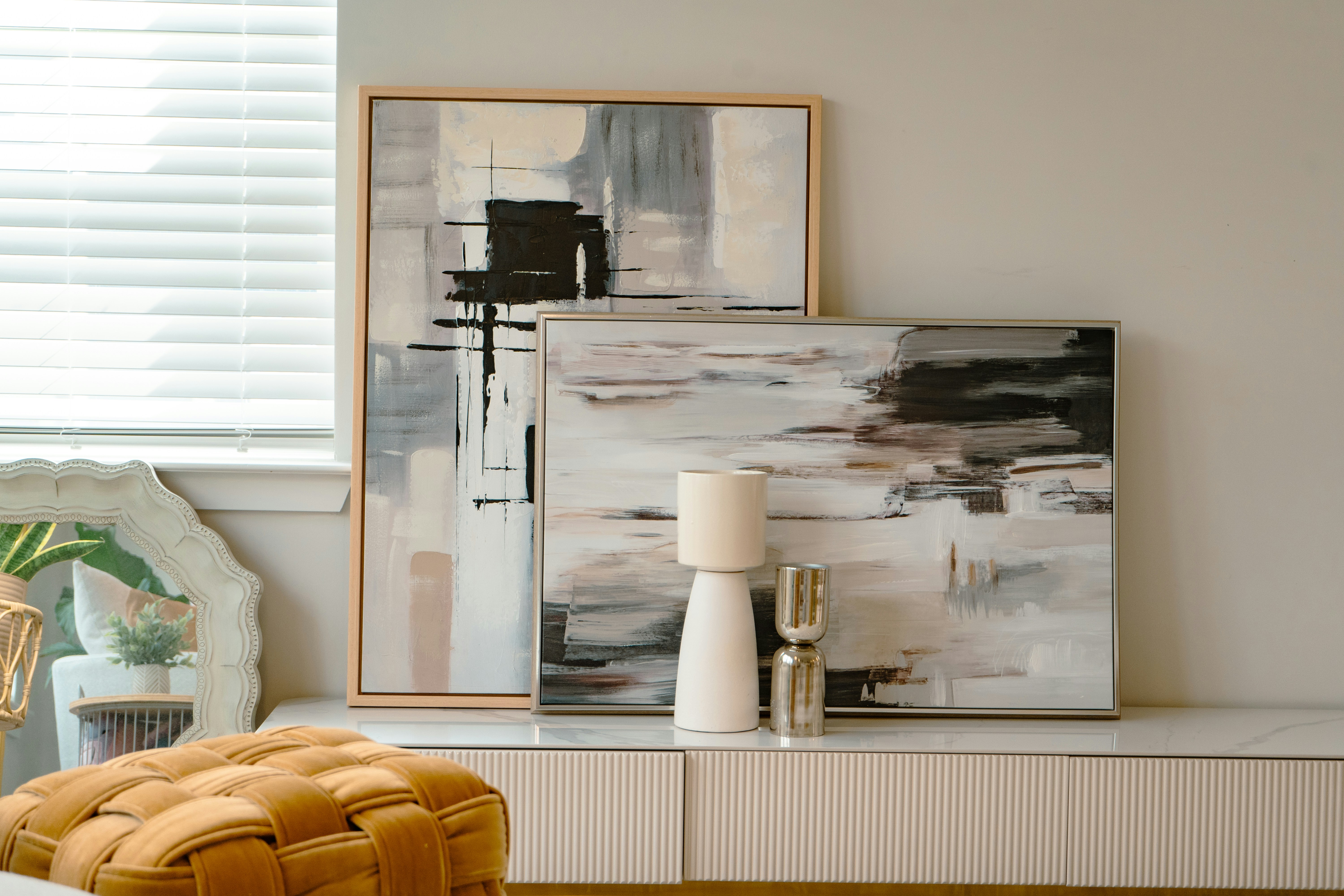 A living room filled with furniture and a painting on the wall