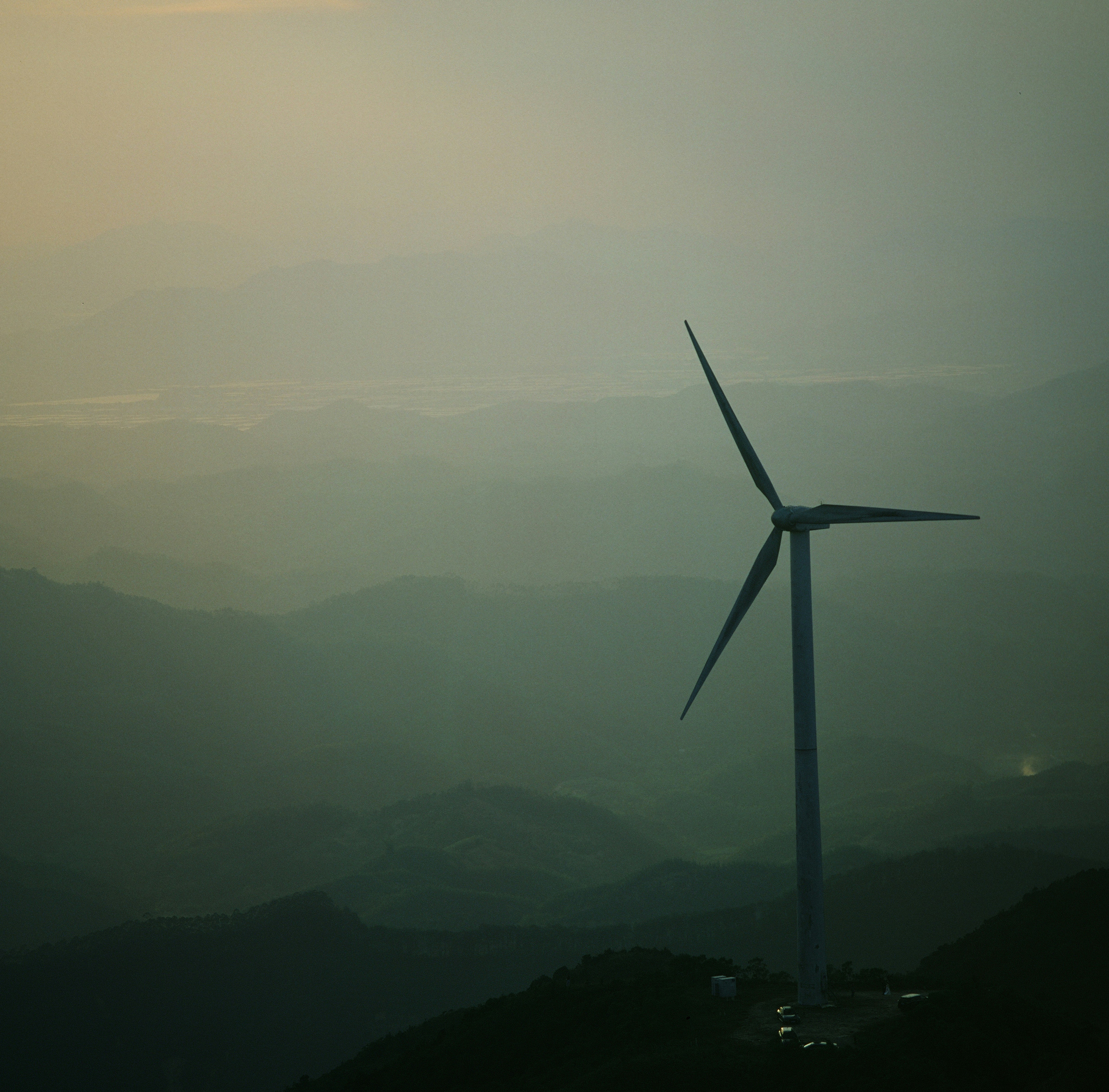 A wind turbine on top of a mountain