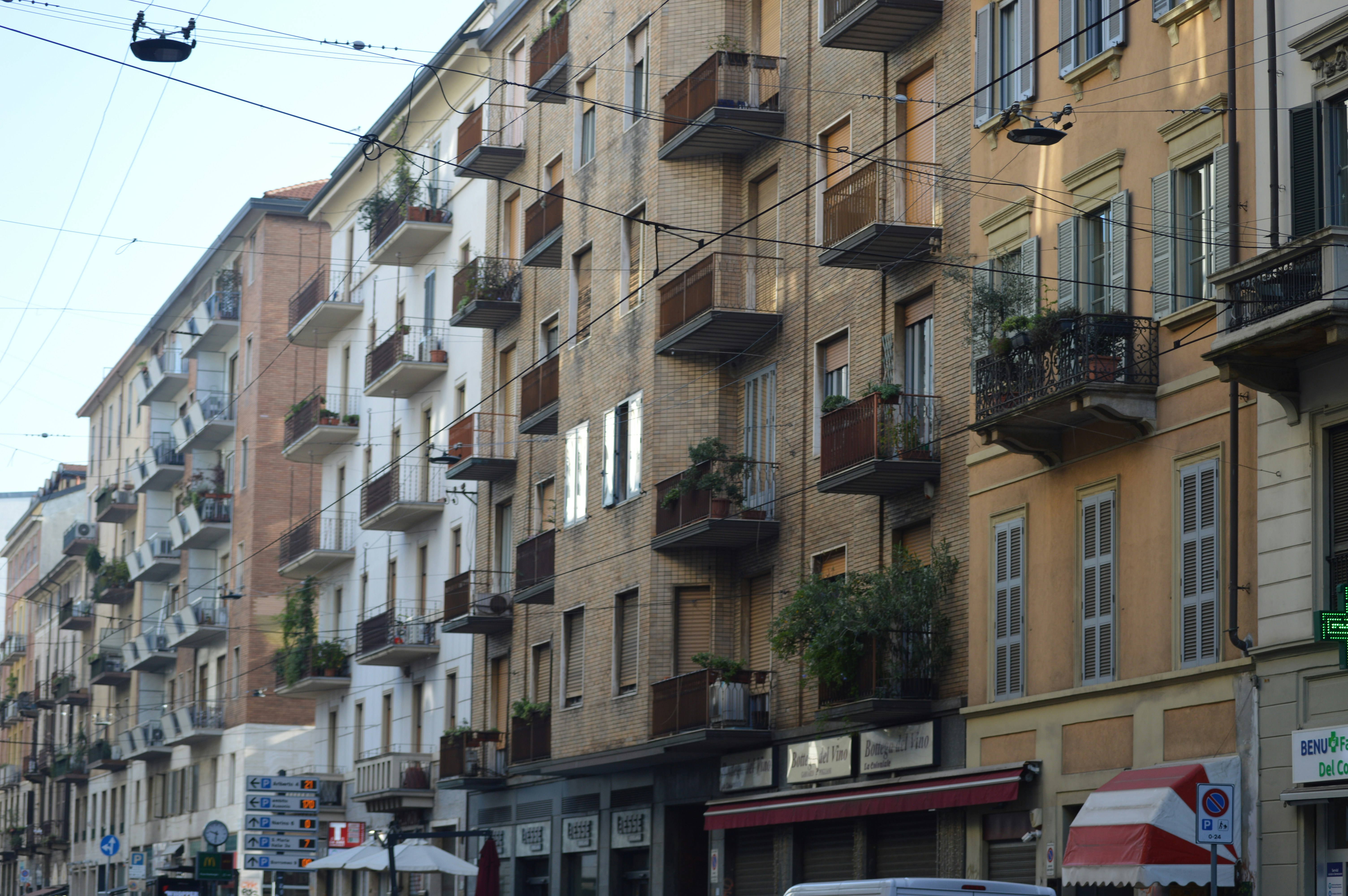 A city street filled with lots of tall buildings, Essence of Milan, Italy, through its bustling streets, These images highlight the city