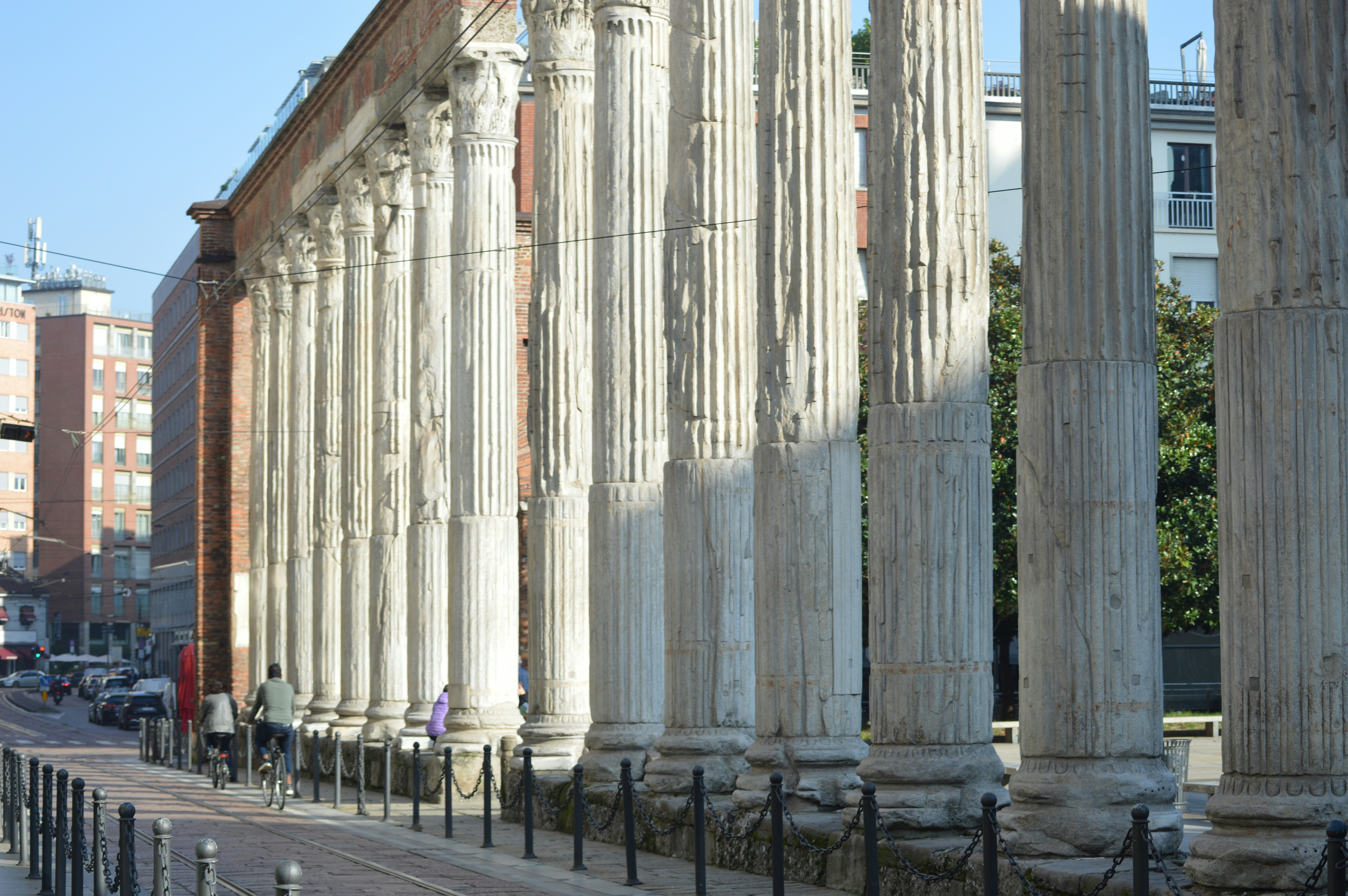 A row of columns on the side of a street