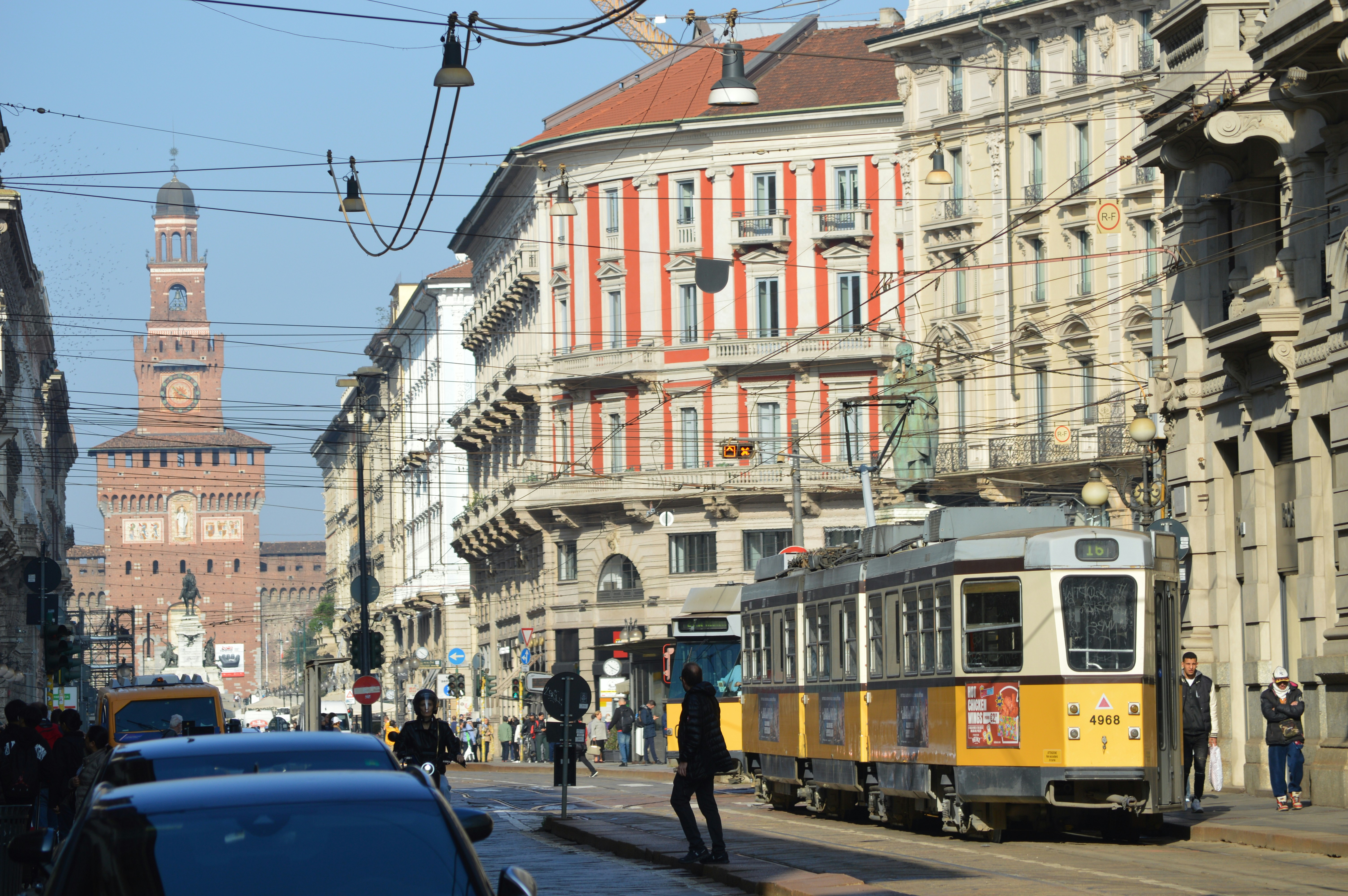 A street scene with a trolley and cars