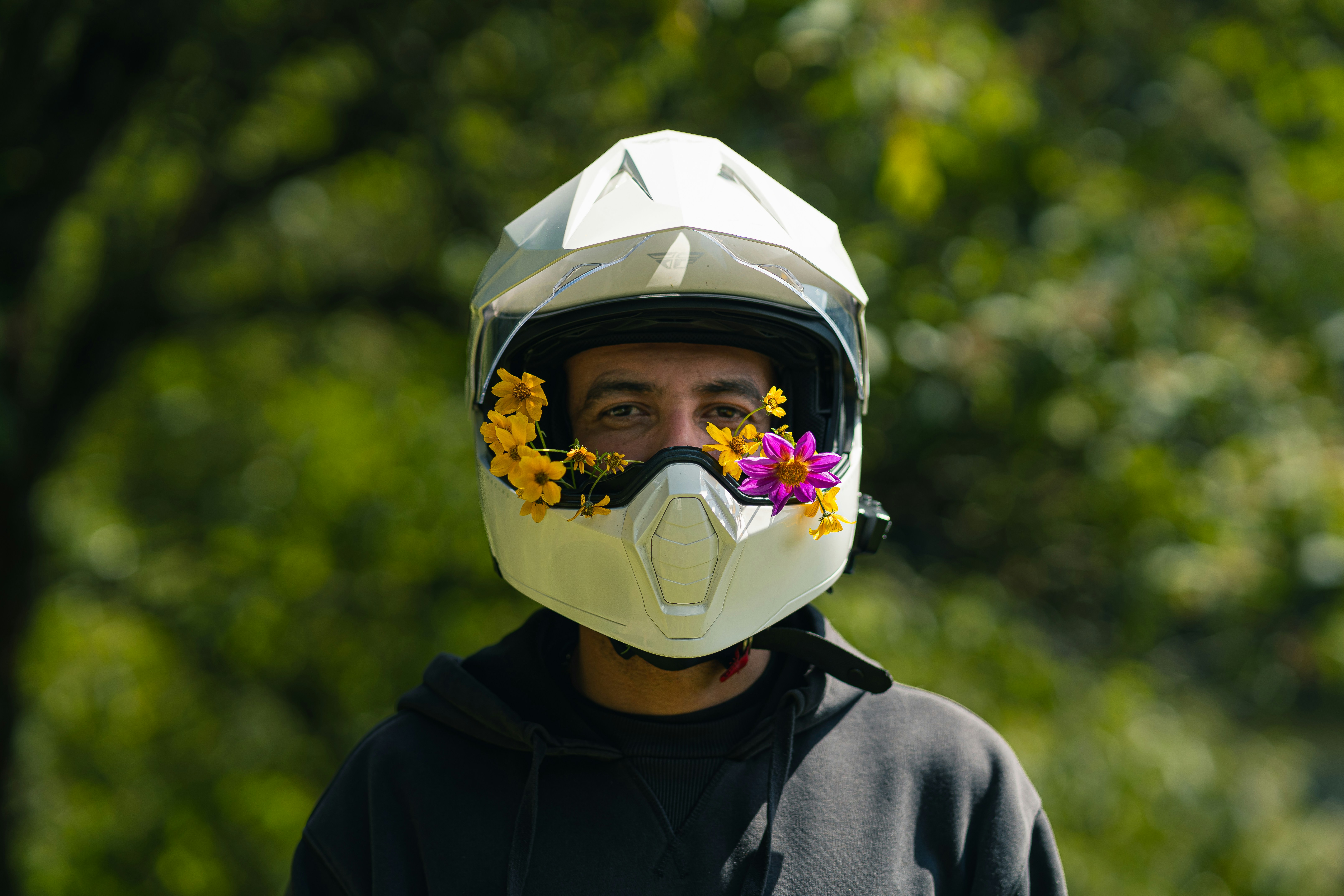 A man wearing a helmet with flowers on it
