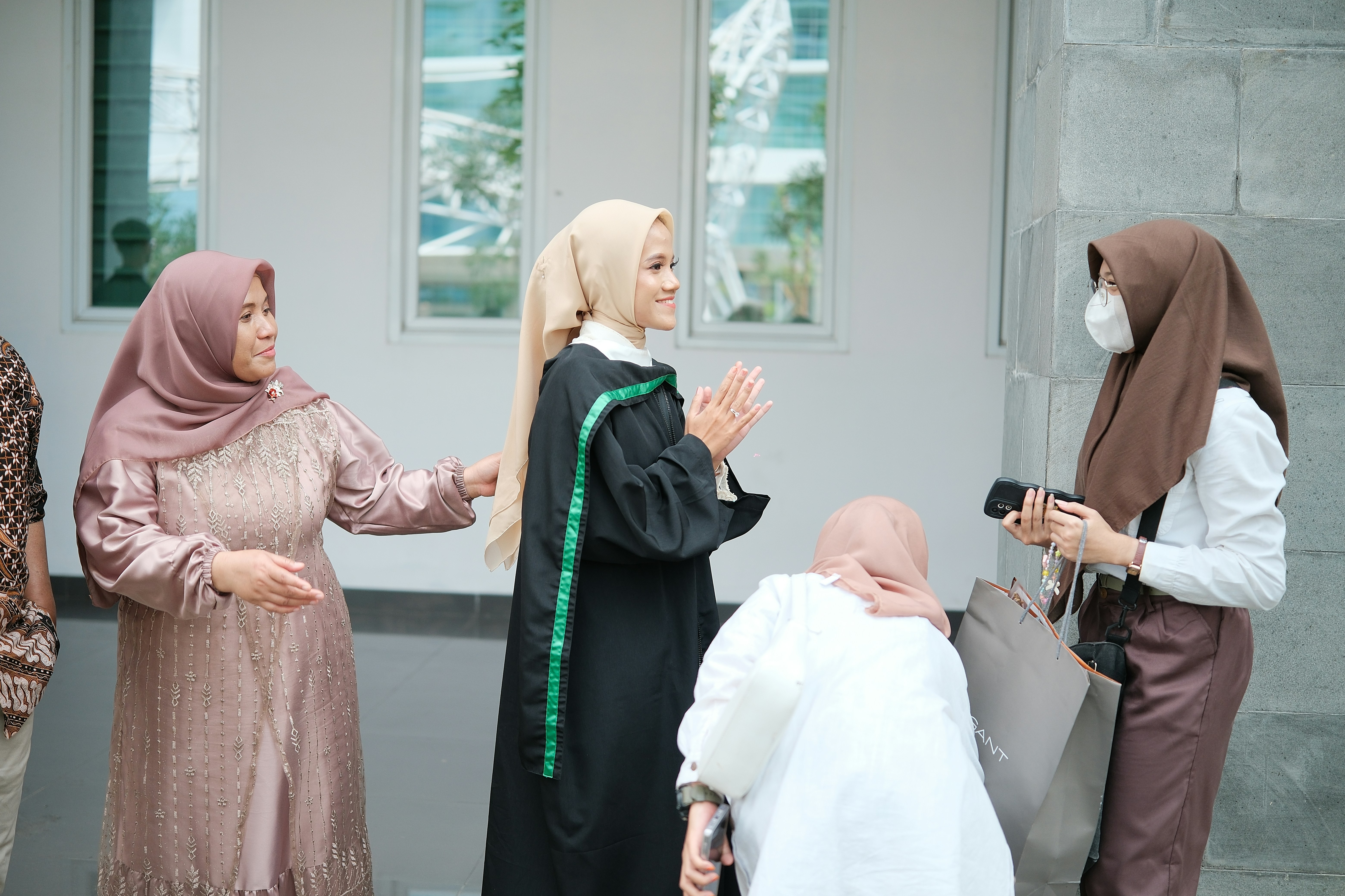 A group of people standing around each other