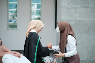 A group of women standing next to each other in front of a building