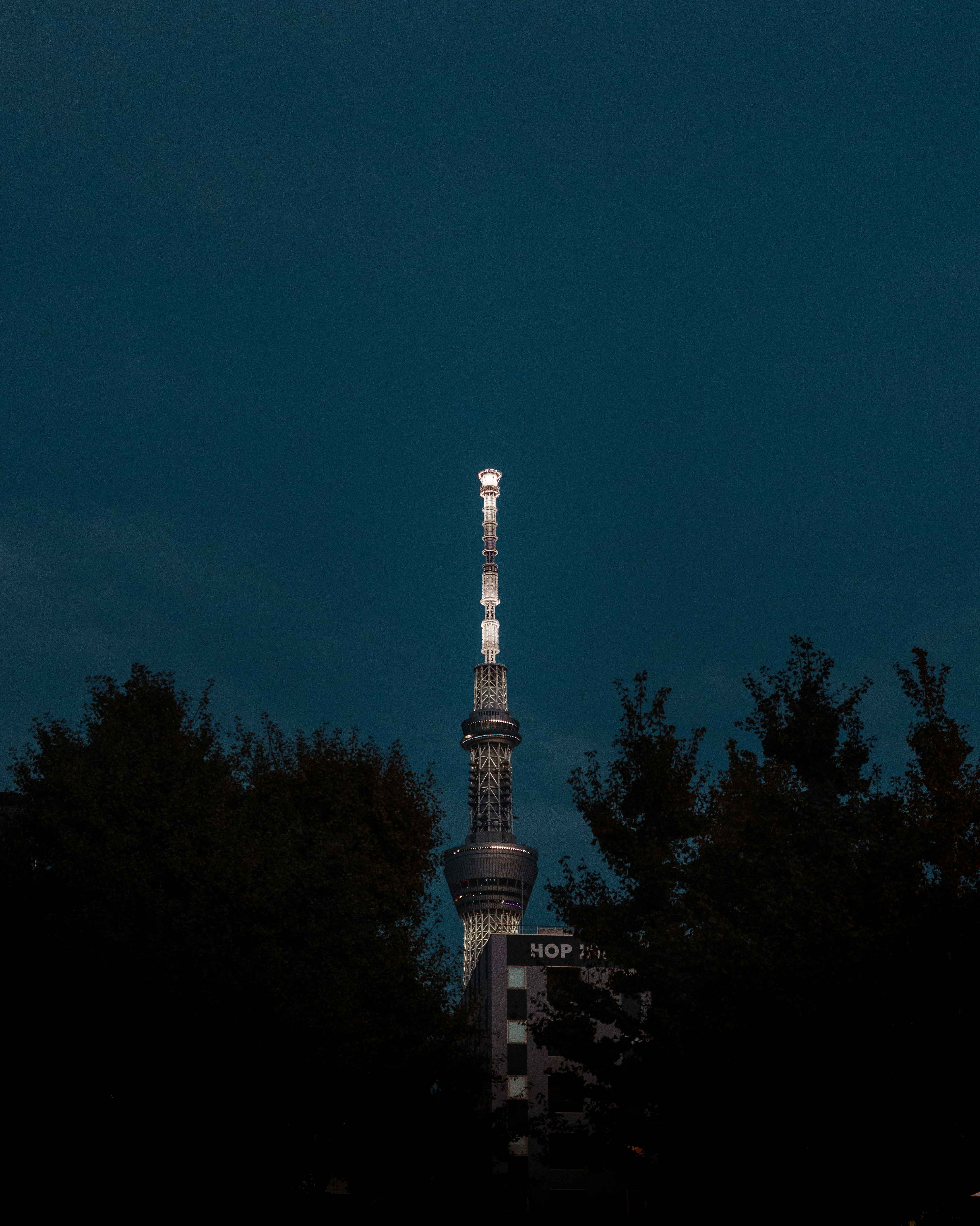 A very tall tower with a clock on it's side