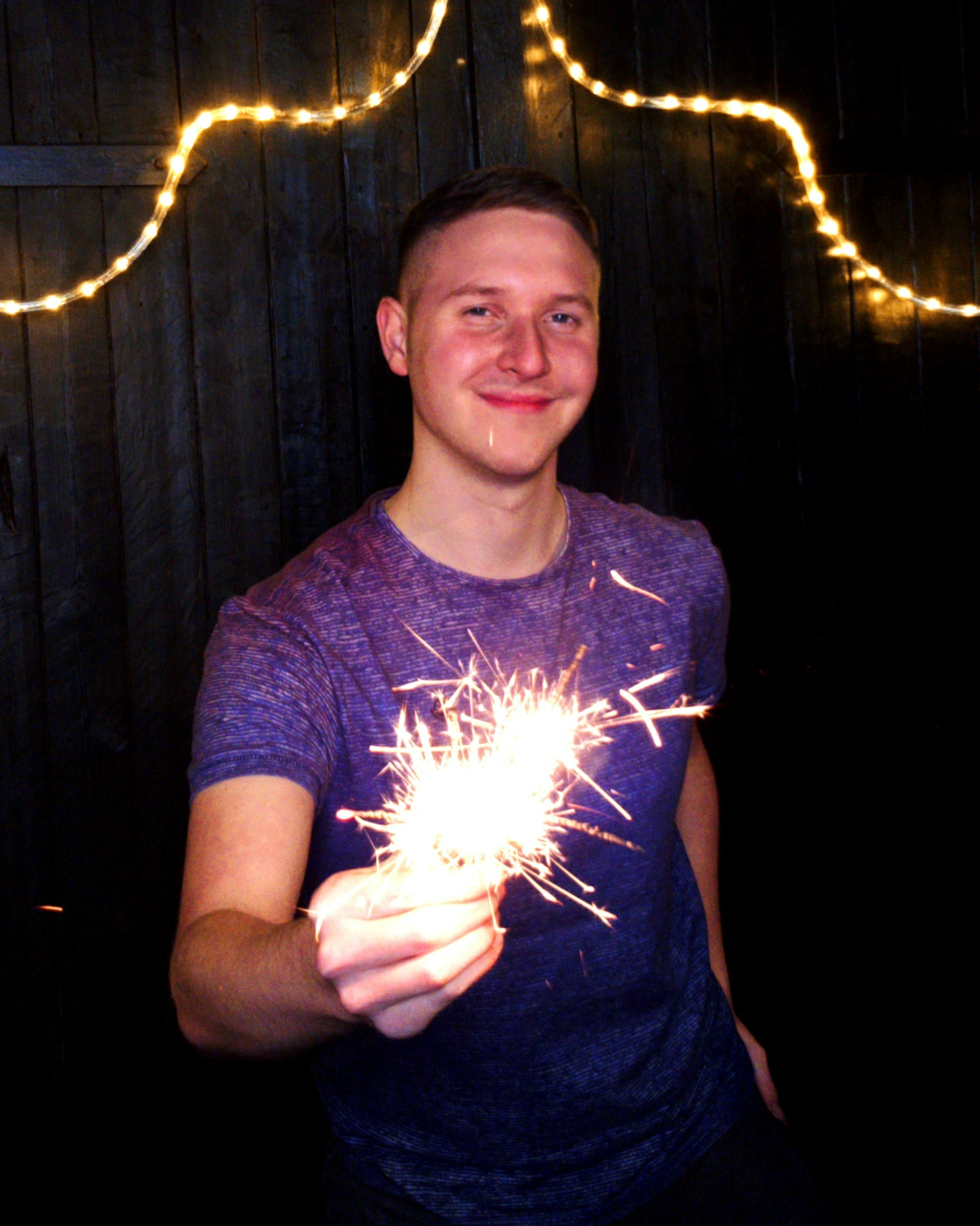 A man holding a sparkler in his hands