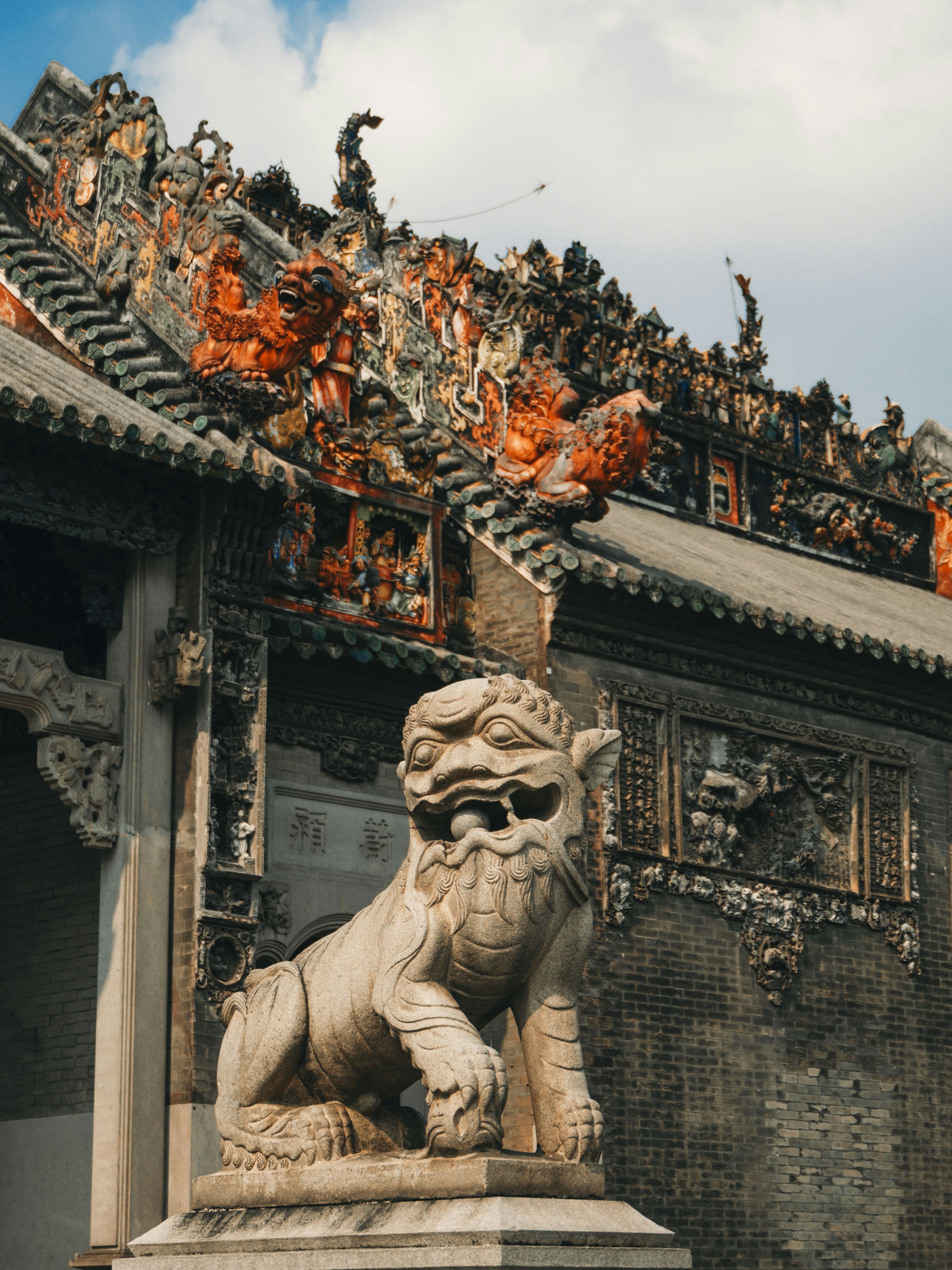 A statue of a lion in front of a building