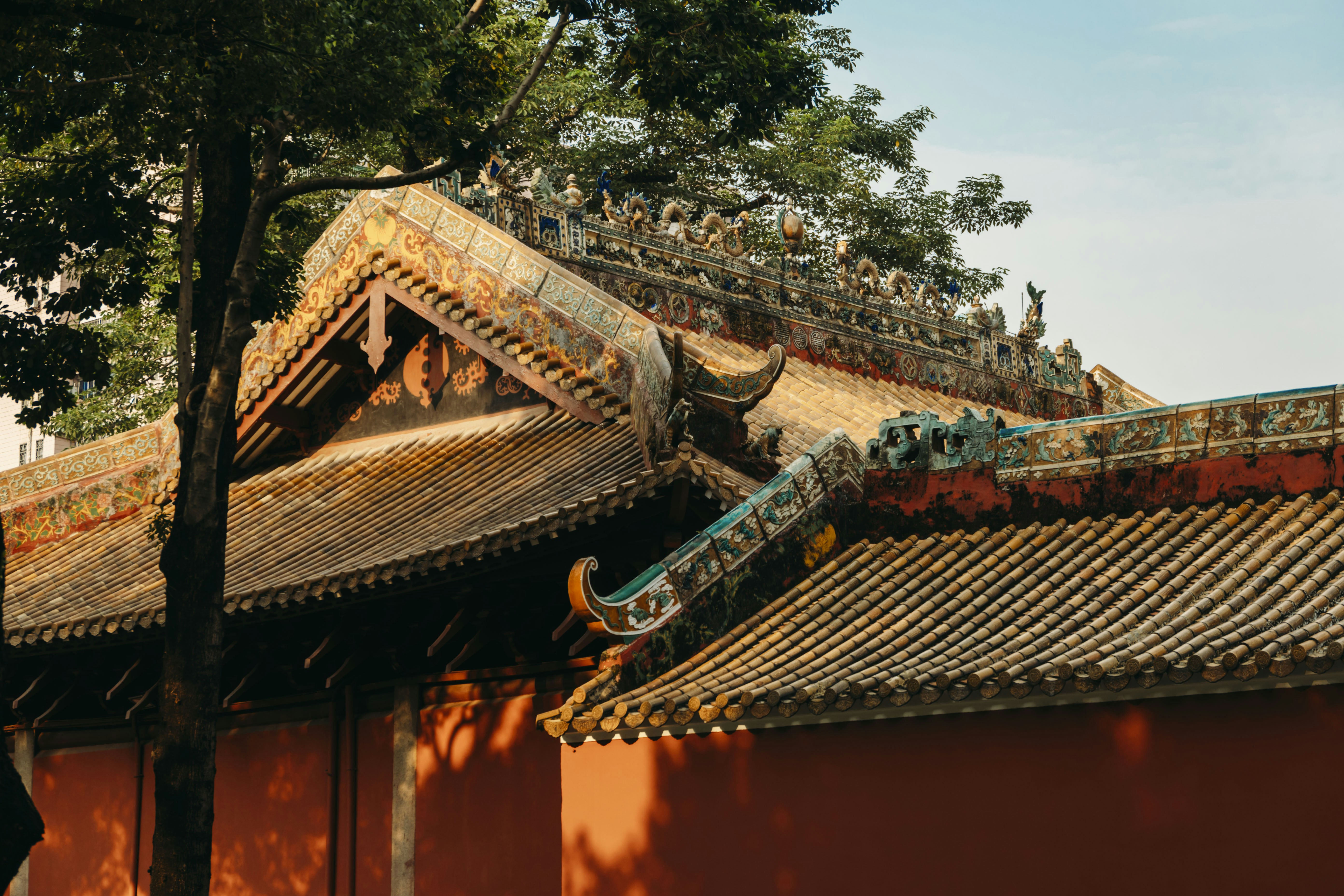 A red building with a tree in front of it