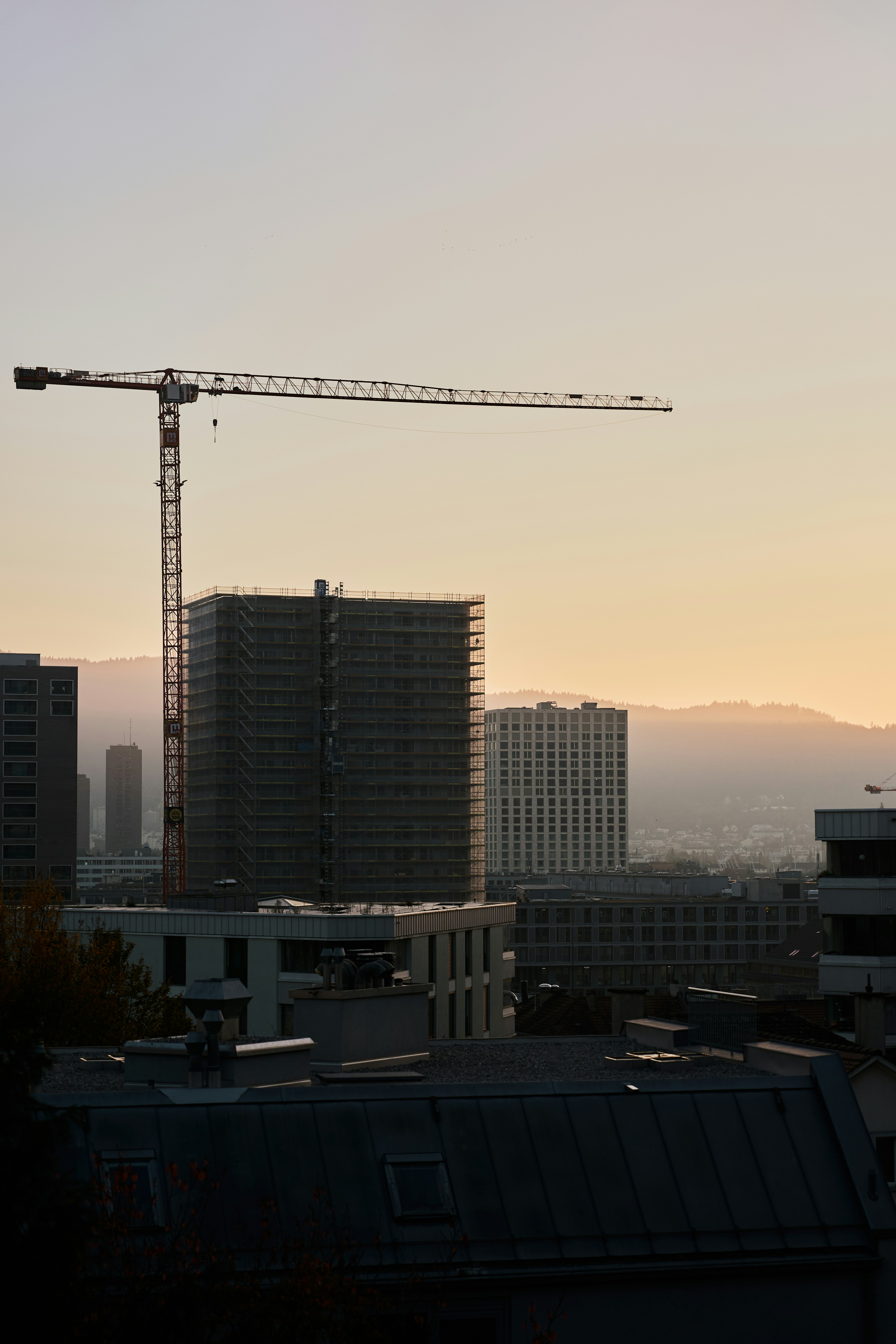 A view of a city with a crane in the background