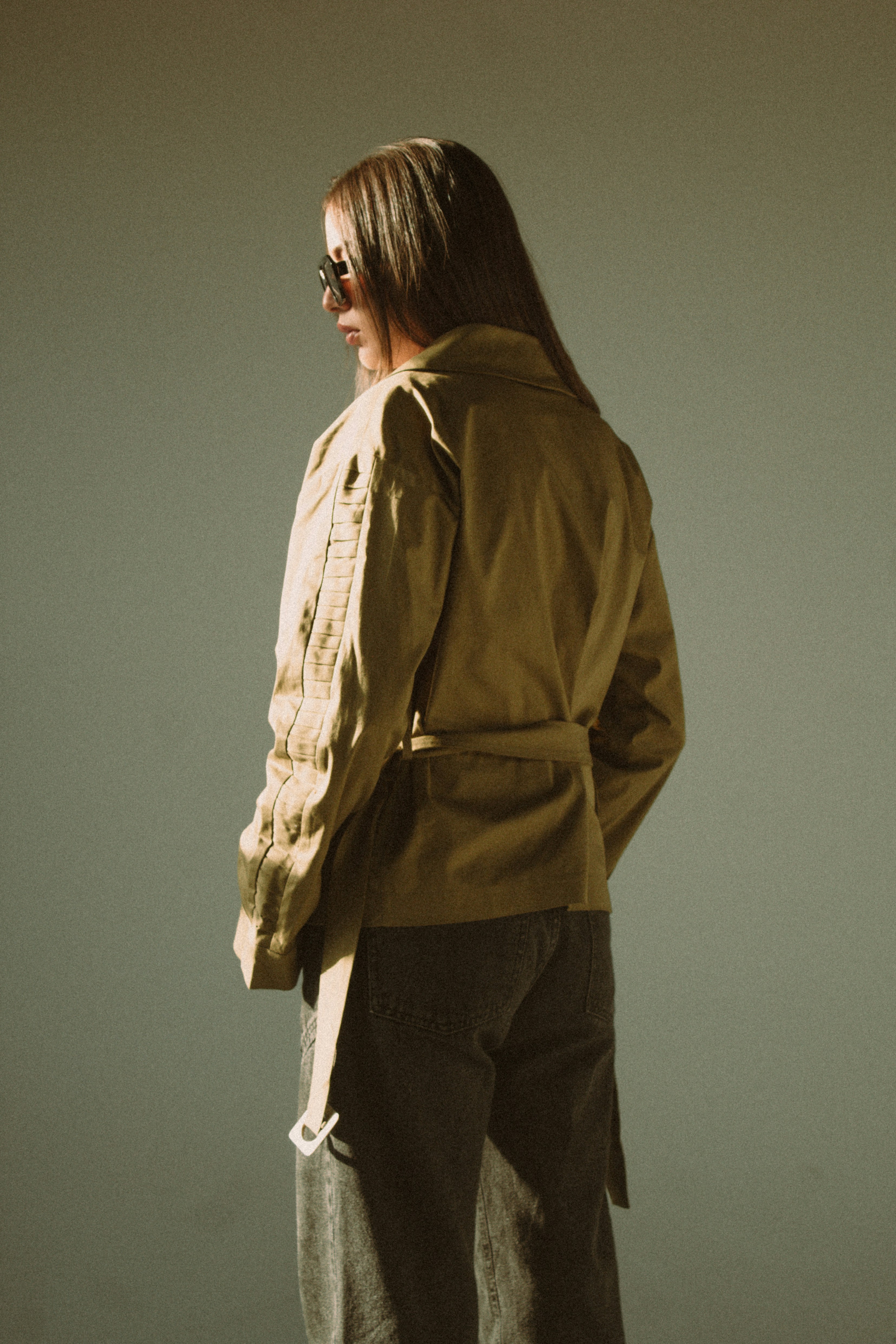 A man with long hair wearing a jacket and pants