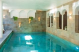 A large indoor swimming pool with blue water