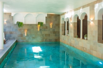 A large indoor swimming pool with blue water