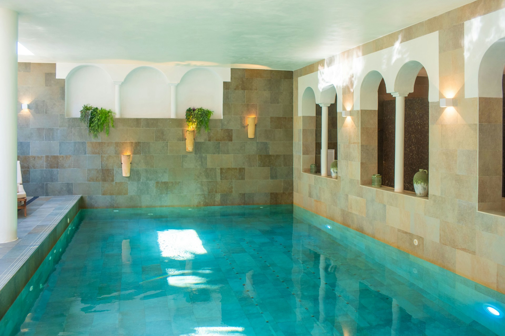 A large indoor swimming pool with blue water