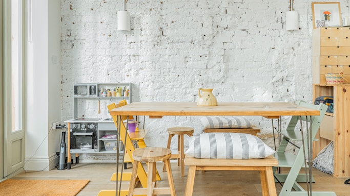 A dining room with a table and chairs