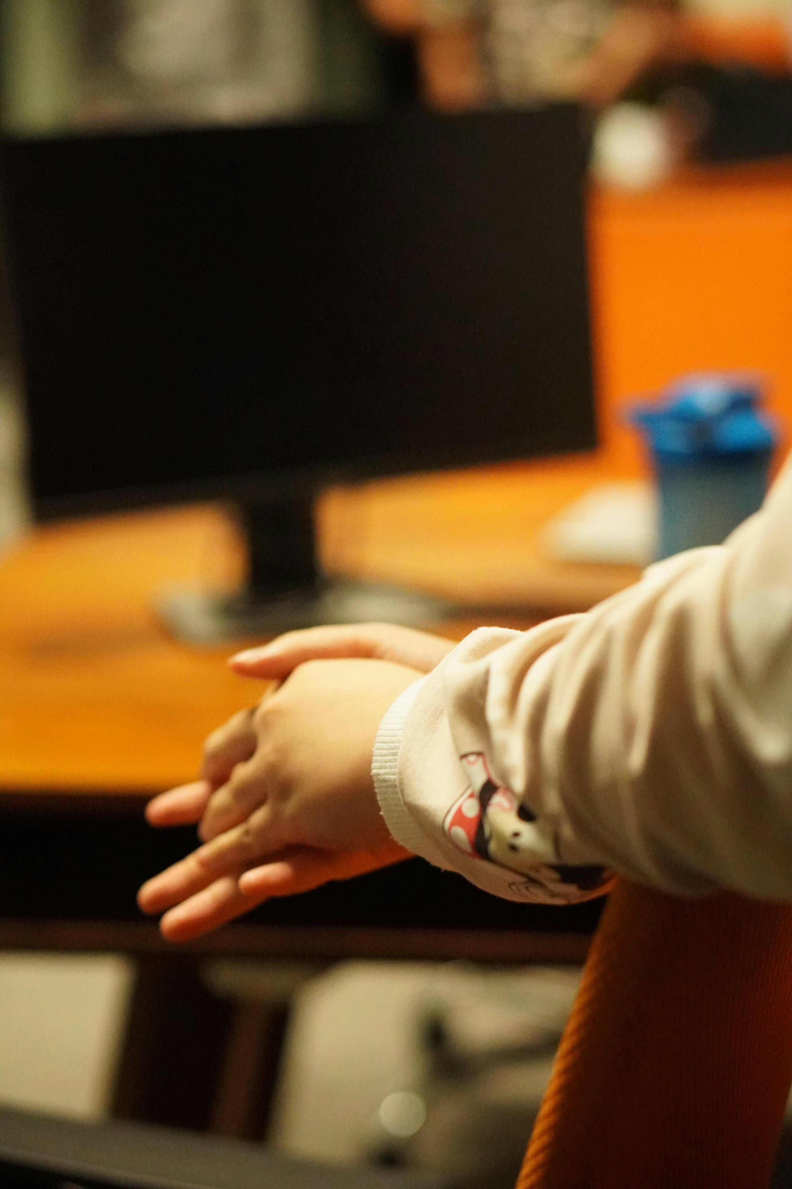 A person sitting at a table with a laptop